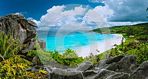 Picturesque panoramic shot of Grand Anse, La Digue island, Seychelles. Huge granite rock formation, bright white sand