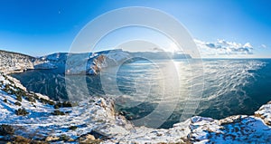 A picturesque panoramic view of the winter snow-covered Balaklava Bay, the ruins of the Genoese fortress Chembalo. Sevastopol,