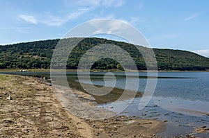 Picturesque Rabisha lake with authentic shore, bivouac and mountain over Magura cave