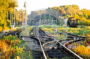 The picturesque railway station in the forest at sunset