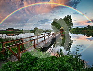 Picturesque rainbow over a wooden hut on a small island