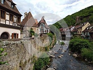 The picturesque river crossing the center of Kaysesberg, surrounded by houses in Rhenish style.