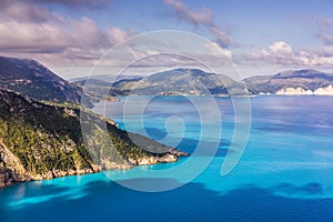 Picturesque rocky coastline on Kefalonia island. Amazing watercolor landscape in sunset light with cloudscape