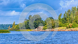 Picturesque rocky shore of the island with huge multi-ton boulders erratic blocks. Baltic fundamental crystalline formations and