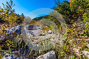 A Picturesque Scene with Beautiful Fall Foliage and Large Granite Boulders at Lost Maples