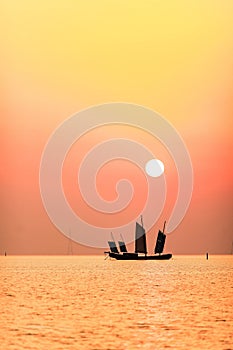 Picturesque scene of a boat floating in the calm waters at sunset