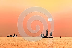 Picturesque scene of boats floating in the calm waters at sunset