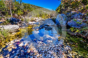 A Picturesque Scene with Fall Foliage on a Babbling Brook and Large Boulders at Lost Maples