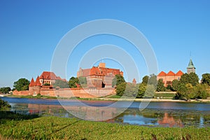 Picturesque scene of Malbork castle on Nogat river, Poland photo