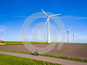 A picturesque scene of a wind farm in Flevoland, Netherlands, with multiple towering windmills
