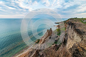 Picturesque sea coast with sand cliffs