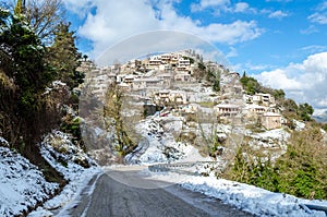 Picturesque Snowy Village with Traditional Houses in Amphitheatrical Architecture on a Sunny Day of Winter in Greece