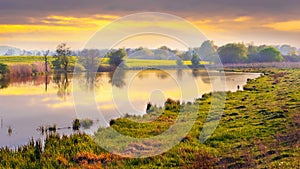 Picturesque spring landscape, sunset on the river, reflection of the sky in the river