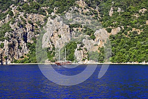 Picturesque spring, summer seascape. Yacht at sea in Turkey, against the backdrop of high mountains, near Bodrum and Marmaris,