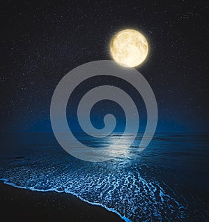 Picturesque starry sky with full moon over sea at night