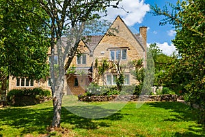 Picturesque stone cottage house on sunny day