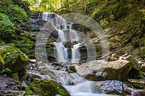 Picturesque stormy waterfall in the forest