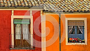 Picturesque street lined with colorful buildings adorned with gorgeous flower pots