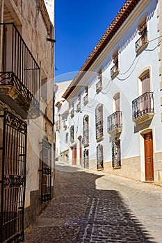 Picturesque streets with whitewashed houses and barred windows in the Andalusian village of Velez Rubio. photo