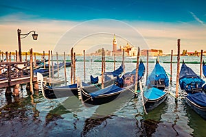 Picturesque summer view of the gondolas parked beside the Riva degli Schiavoni in Venice, Italy, Europe. Splendid Mediterranean sc