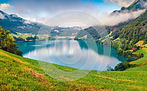 Picturesque summer view of Lungerersee lake. Colorful morning scene of Swiss Alps, Lungern village location, Switzerland, Europe.