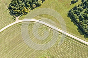 Picturesque sunny rural landscape. dirt road crossing agricultural fields. top aerial view