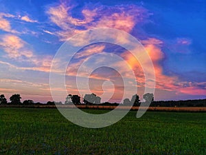 Picturesque sunset, over the fields in the village of Mietkie, Warmian-Masurian province.