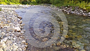 Picturesque Thaw river in the Vale of Glamorgan, banks covered with stones