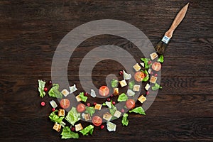 Picturesque top view composition of fresh healthy salad components on wooden table.