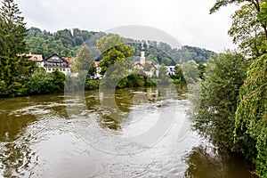 Picturesque town on a forested river bank