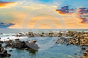 Picturesque tropical beach with boulders and sunrise