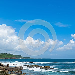 Picturesque tropical beach with coastal rocks