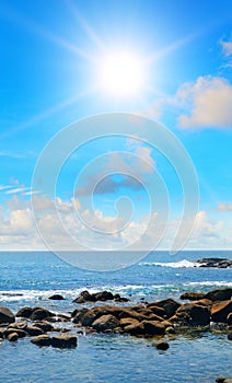 Picturesque tropical beach with coastal rocks. Vertical photo