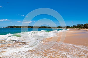 Picturesque tropical beach with sand and waves