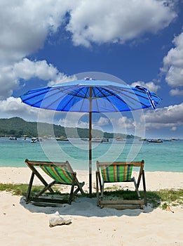 A picturesque umbrella and chaise lounges