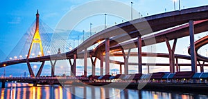 Picturesque underneath view of highway interchange and suspension bridges at dusk