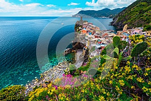 Picturesque Vernazza village and colorful mediterranean flowers, Cinque Terre, Italy