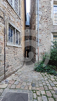 picturesque very narrow alley of the old town of Le Mans in France, old style inner courtyard