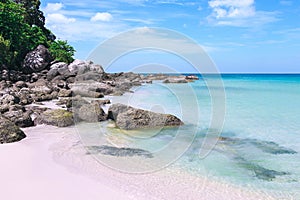 Picturesque view of Andaman sea in Phuket island, Thailand. Seascape with white sand, cliff and blue sky.