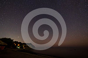 Starry sky over beach and sea