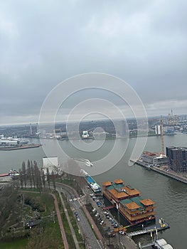 Picturesque view of city with modern buildings and harbor on cloudy day