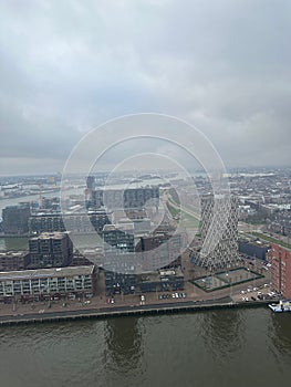 Picturesque view of city with modern buildings and harbor on cloudy day