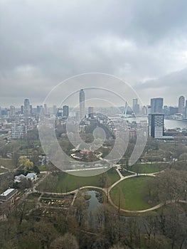 Picturesque view of city with modern buildings and park on cloudy day