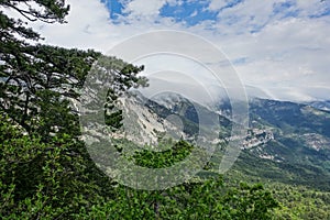 Picturesque view of the city of Yalta and the Black Sea from Ai-Petri mountain in Crimea. Mountain landscape with trees
