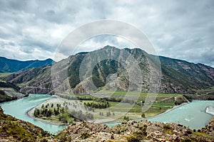 Picturesque view on the confluence of two mountain rivers. Katun river and Chuya river against of Altai mountains, Russia