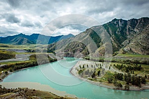 Picturesque view on the confluence of two mountain rivers. Katun river and Chuya river against of Altai mountains, Russia