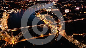 Picturesque view from drone of city of Porto and Dom Luis Bridge at night, Portugal