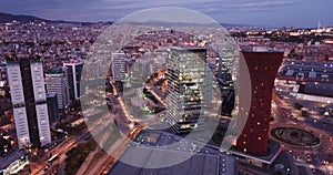 Picturesque view from drone of night Barcelona. Illuminated major business district with modern skyscrapers