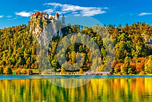 Picturesque view of Lake Bled in autumn, Slovenia. Beautiful landscape with colorful trees on the hills reflected in the water