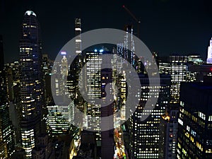 Picturesque view of the lit up modern skyscrapers on a dark night in New York.